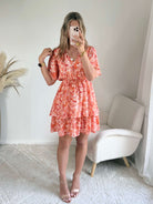 Robe corail à volants Solea, robe courte fluide à imprimé cachemire corail et rose, manches courtes évasées, taille élastiquée et jupe à volants. Modèle féminin et léger idéal pour les journées d’été.