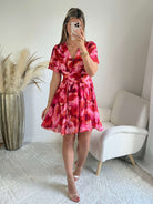 Robe courte Bianca imprimée rose et rouge coupe fluide avec décolleté en V, manches courtes.